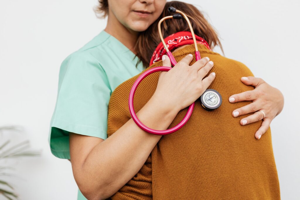 A healthcare professional offering comfort and support to a patient.